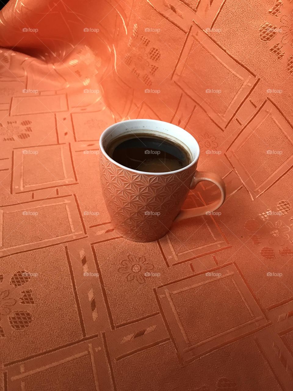 An orange cup of coffee