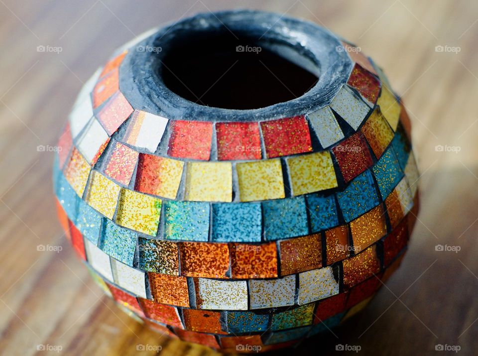 Rainbow covered candle holder.