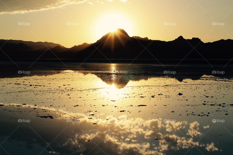 The sunsetting  behind a mountain over looking the Bonneville salt flats. 