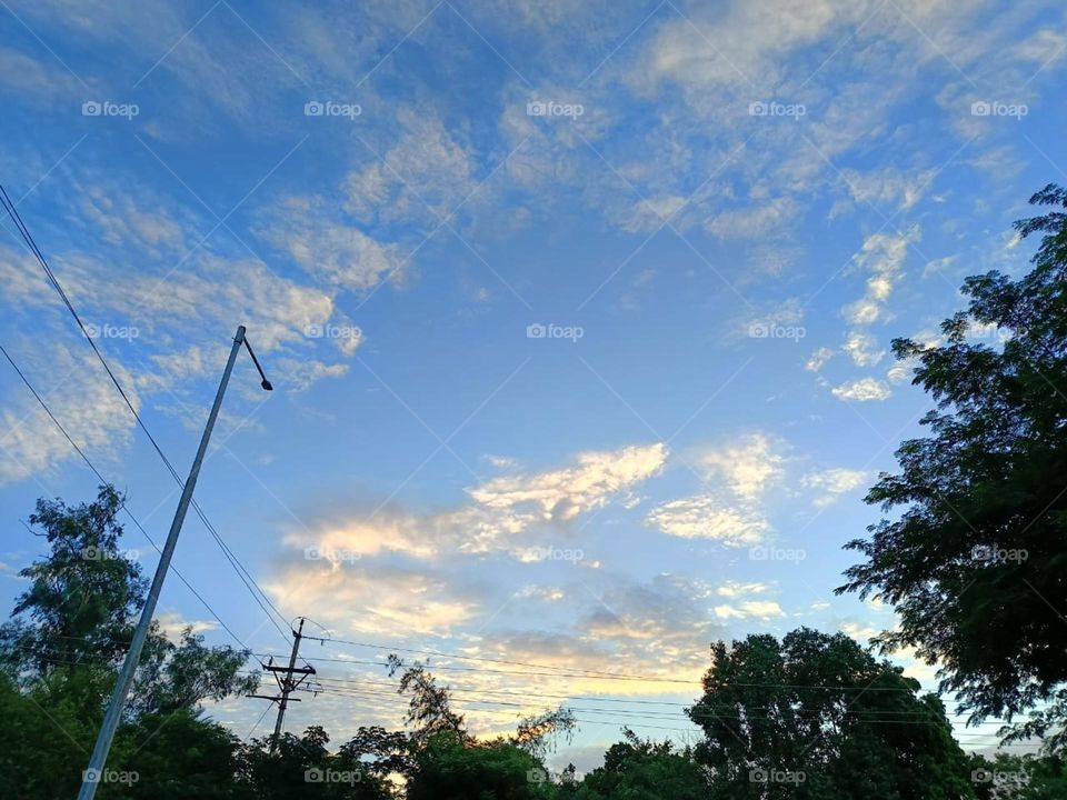 Wow, that tall structure on the road looks impressive against the beautiful sky backdrop! It's like reaching for the clouds! 🌤️