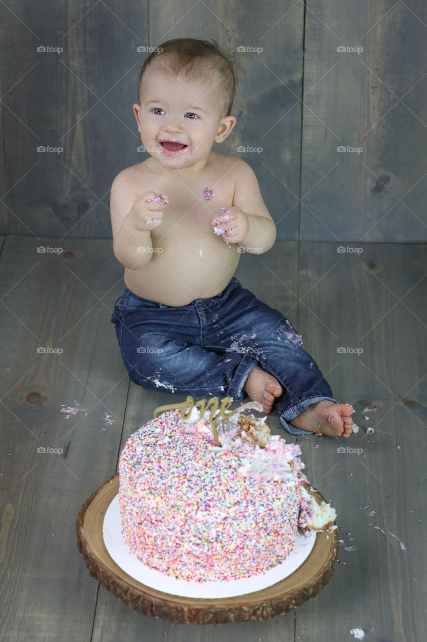 Baby sitting in front of cake