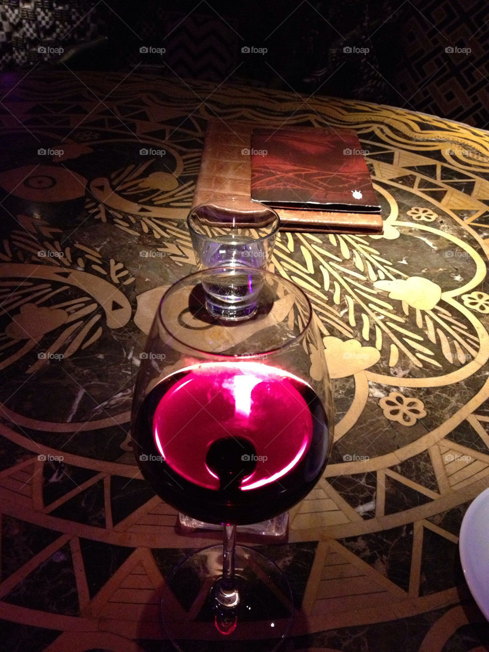 Candle through red wine.