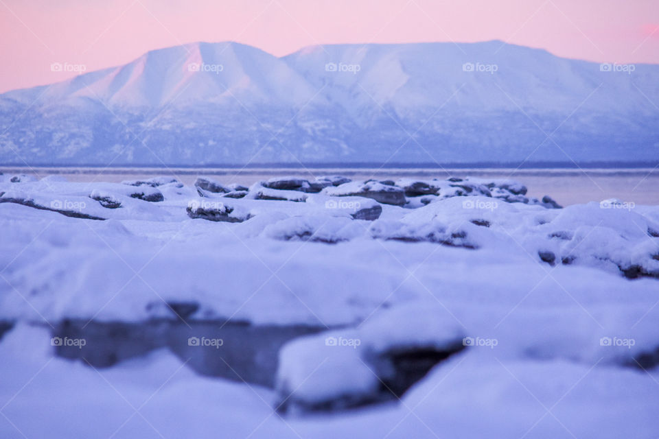 Mt Susitna (also called “the Sleeping Lady”) on a cold winter day surrounded by ice formations in Cook Inlet in Alaska 