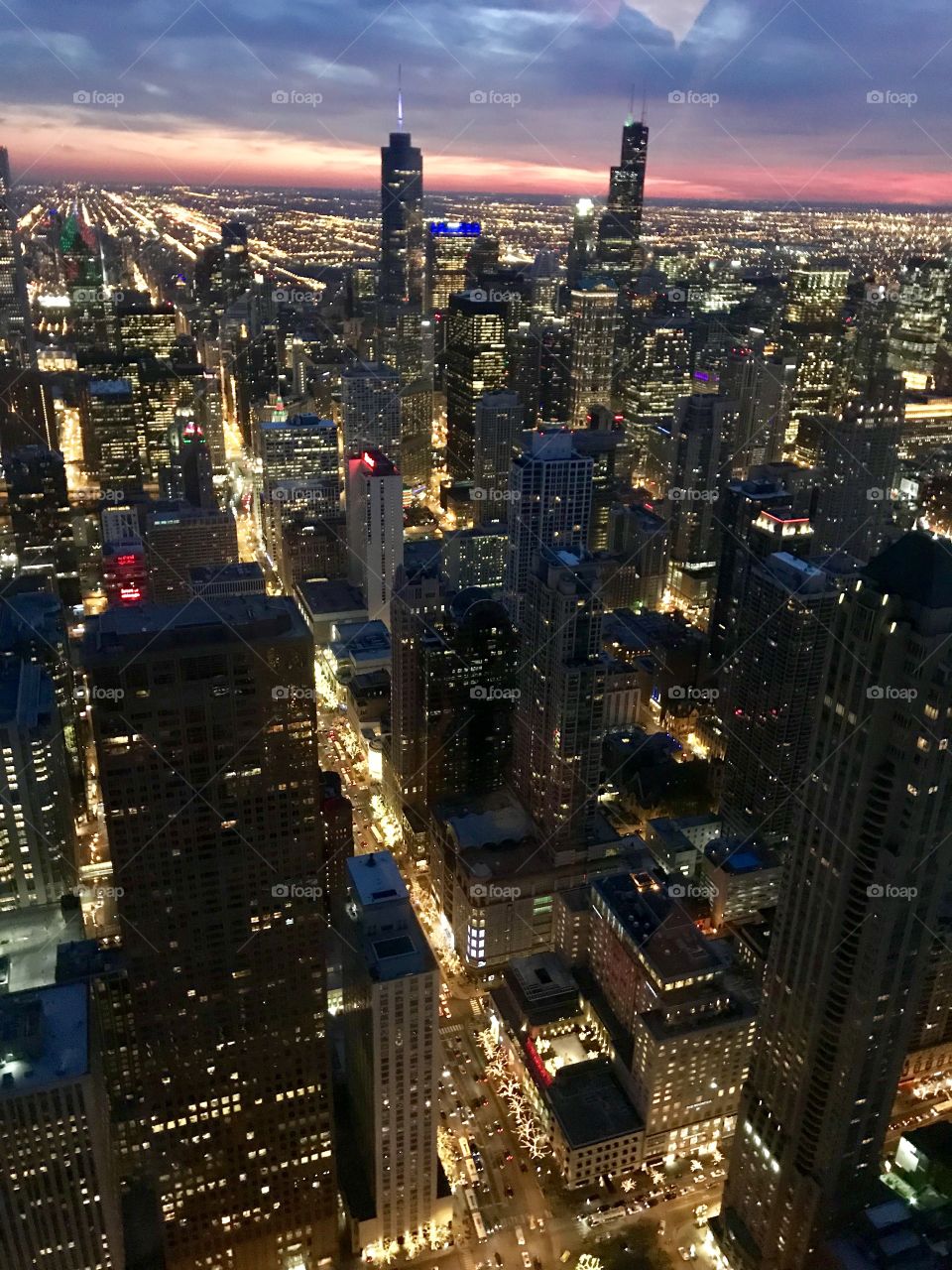 Aerial view of the bustling city of Chicago as the sun sets behind the skyline
