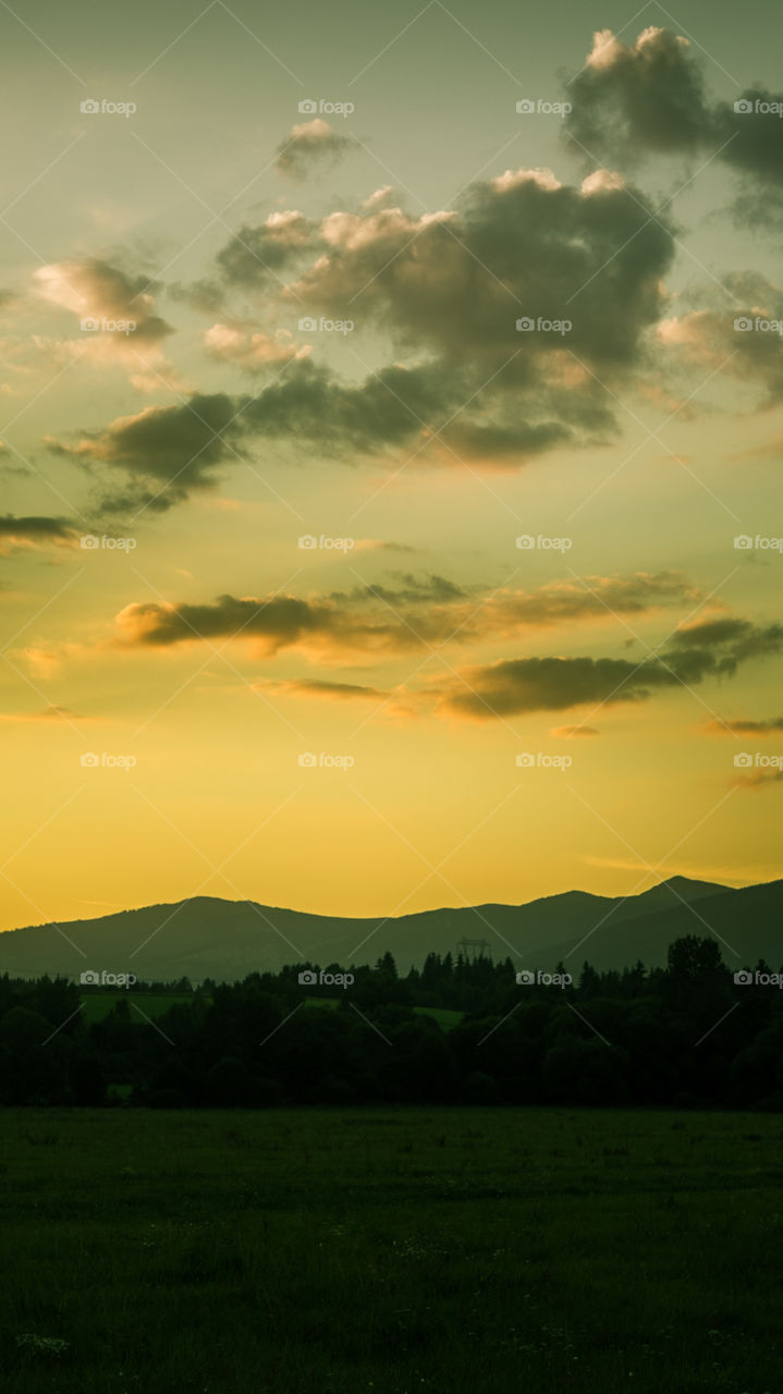 An inspiring mountain landscape. Tatry mountains in Slovakia. A beautiful wallpaper for smartphone screen. Warm summer haze, abstract gradient with perspective.