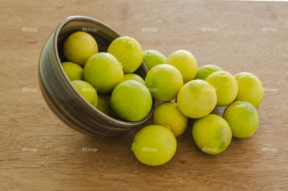 Limes On Wooden Surface