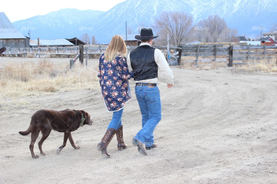 A couple walking with dog