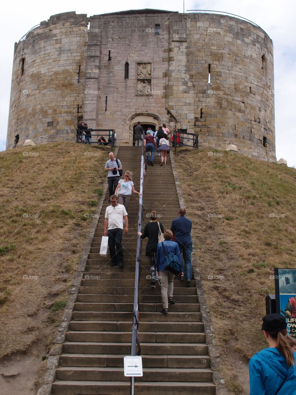 Summer vacationers enjoy Clifford’s Tower in York, England 