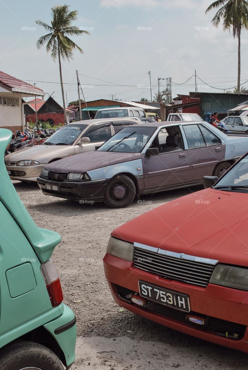 Old unregistered taxi waiting for passengers.