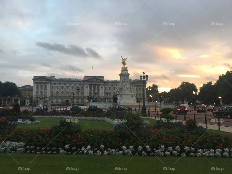 Buckingham Palace as seen during a sunset during a cloudy day 