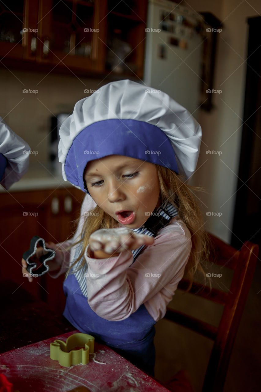 Little sisters cooking the biscuits 