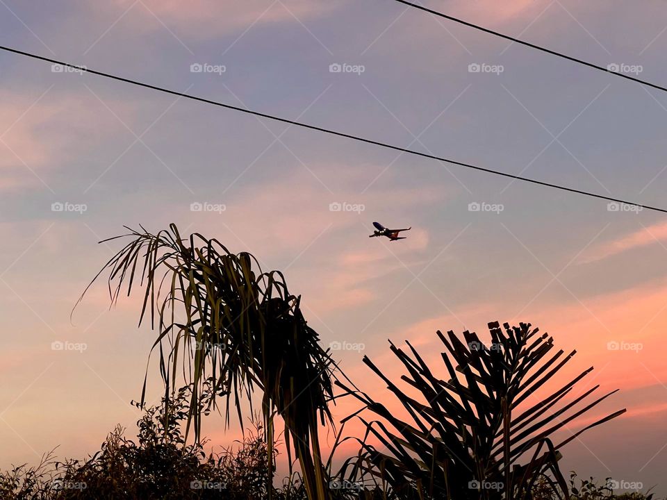 Beautiful sunset near the Upper Newport Bay in Newport Beach California with a plane taking off from John Wayne Airport (SNA)