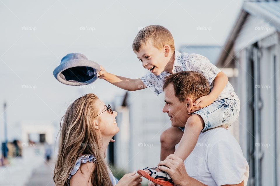 Happy family laughing at the sunset 