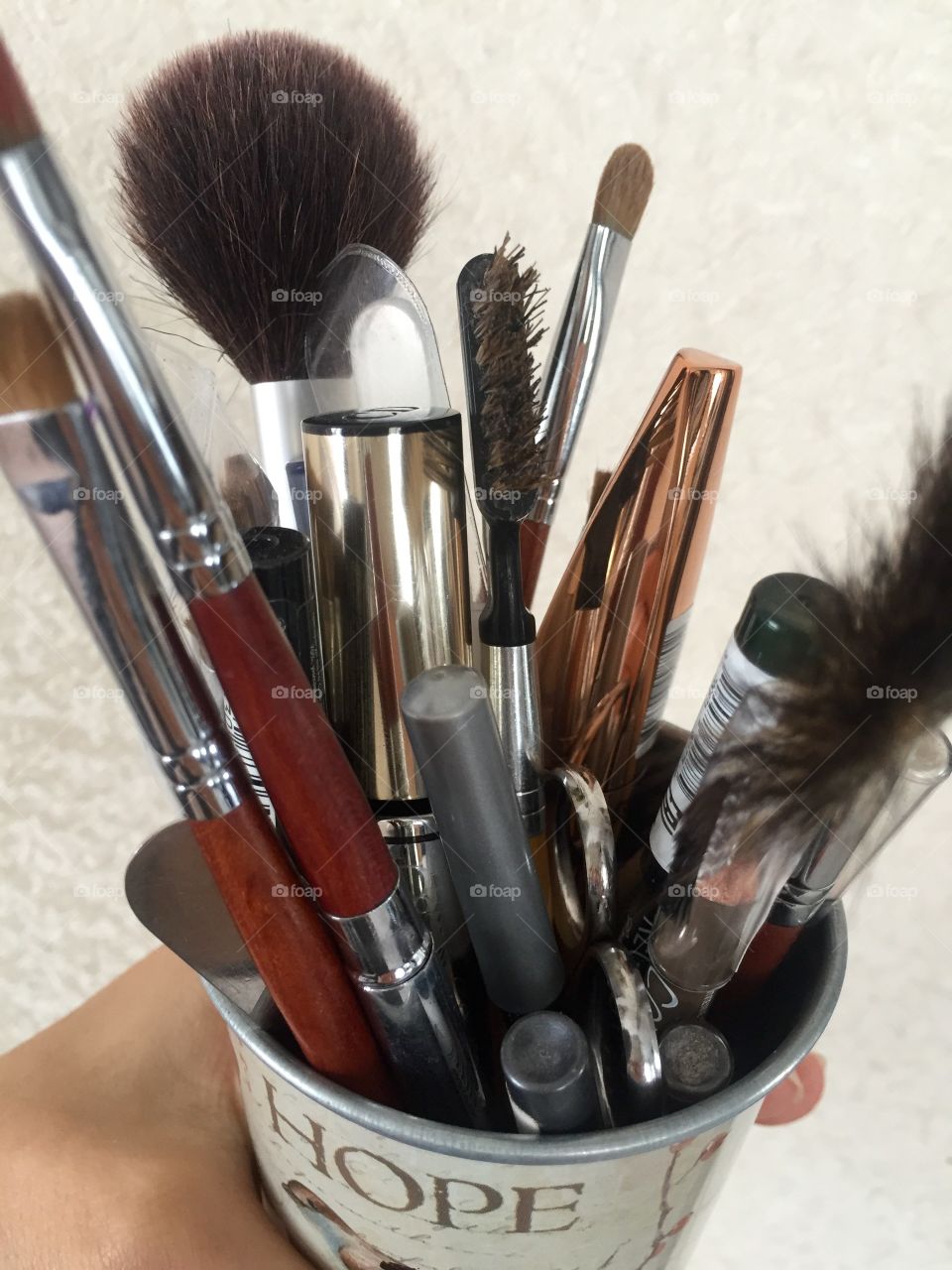 Make up brushes, pencils and mascara in the pot