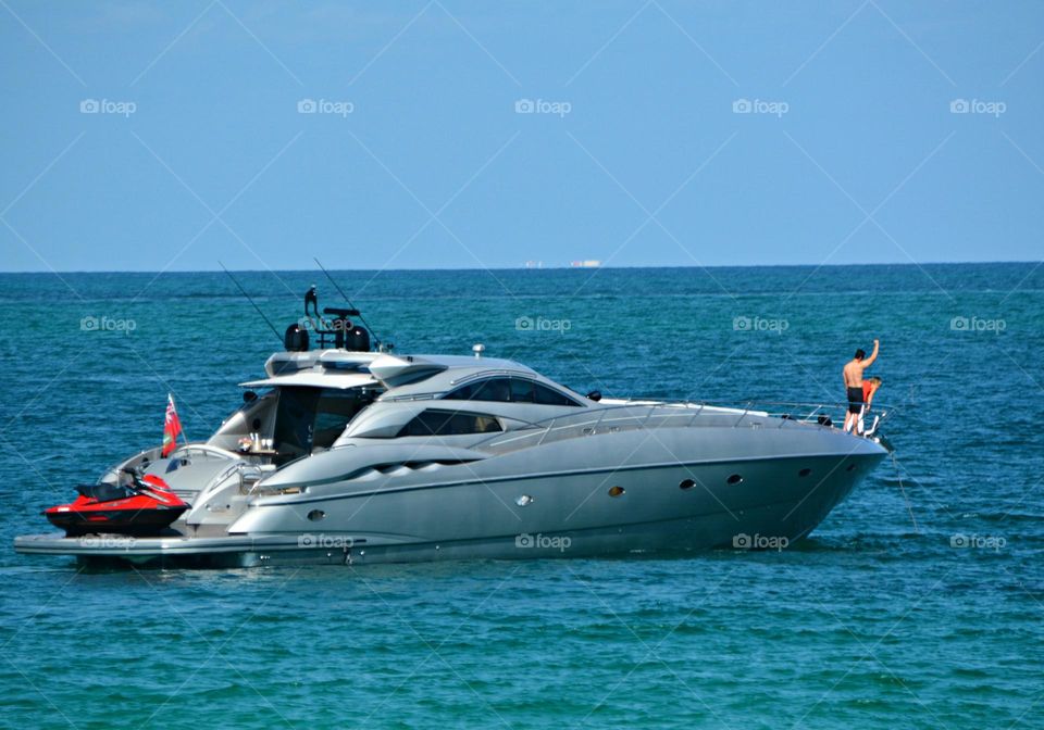 Urban Nature: Water - A family on vacation with their super yacht docked in the bay enjoy diving into the warm water 