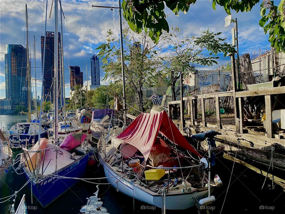This beautiful handcrafted wooden terrace was built by some of the boat owners here at “Newtown Creek” by the “Pulaski Bridge” in LIC, Queens. Get togethers and parties are sometimes held here. 2023. Hypnotic Productions