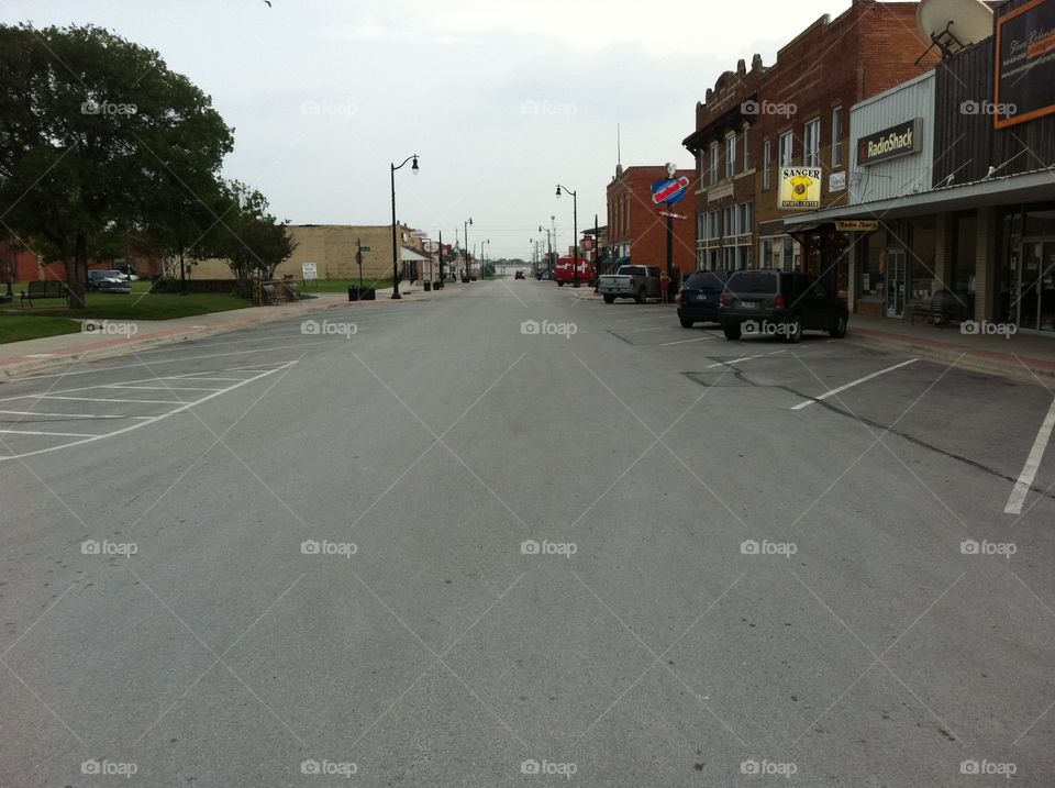 Main Street of Sanger Texas during the day. 