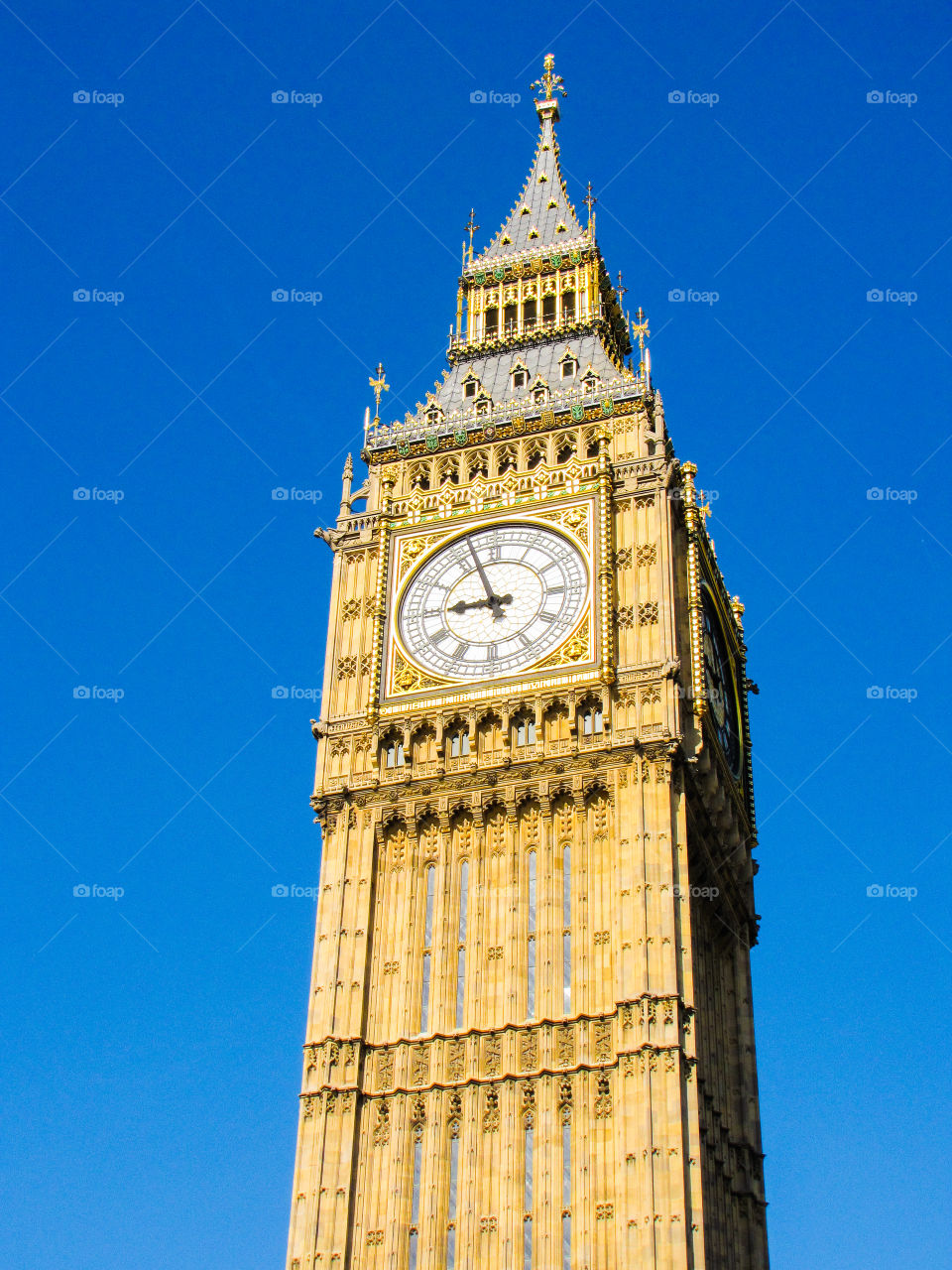 Big Ben clock tower in London against a blue sky