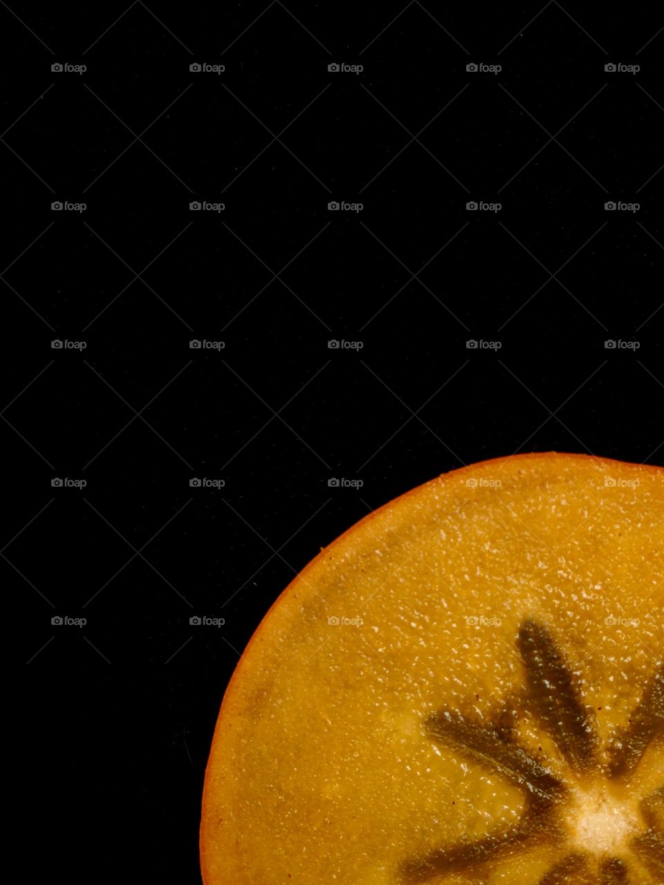 Persimmon slice cut out isolated on black 