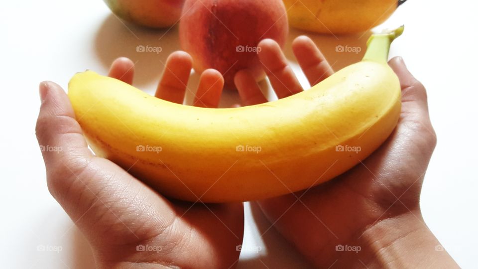 Close-up of hand holding banana