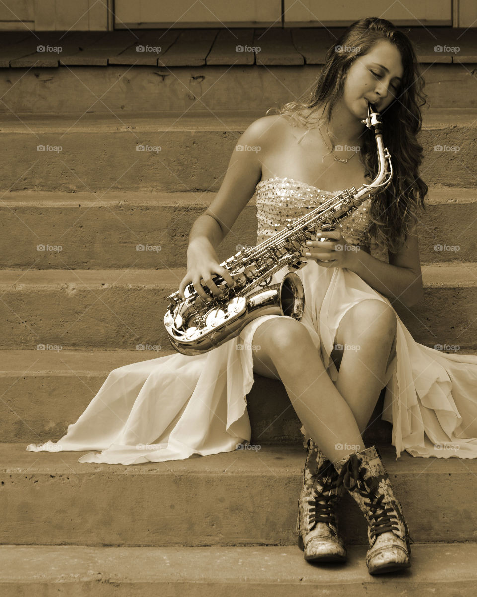 Sax player. Young lady playing a sax 