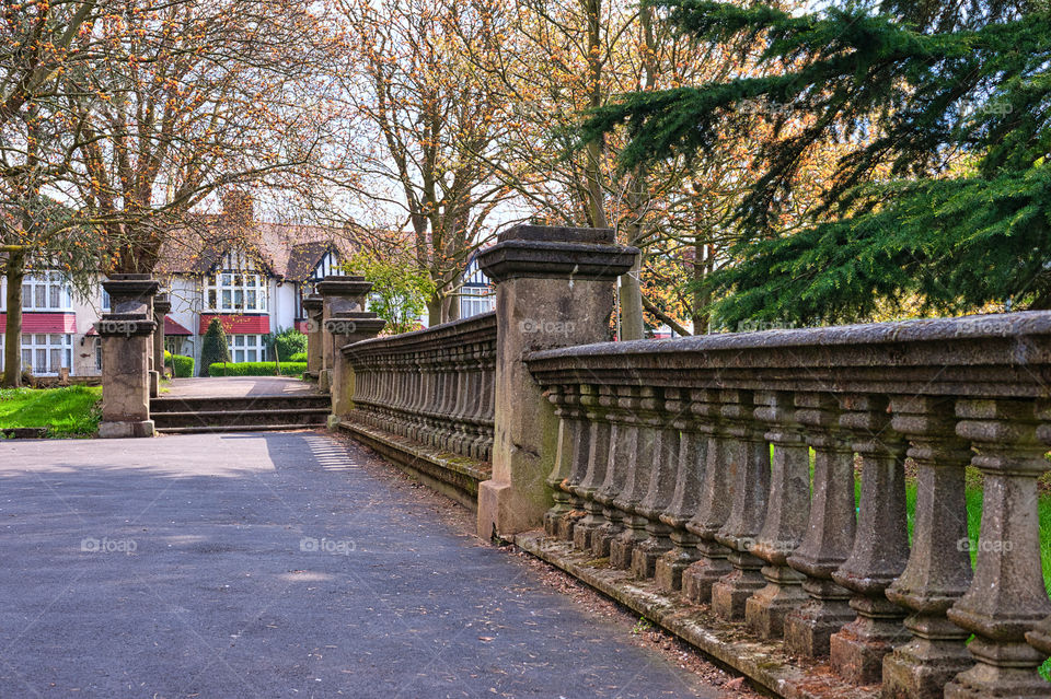 Old stone wall in village commons, communal area for all village residents. UK.