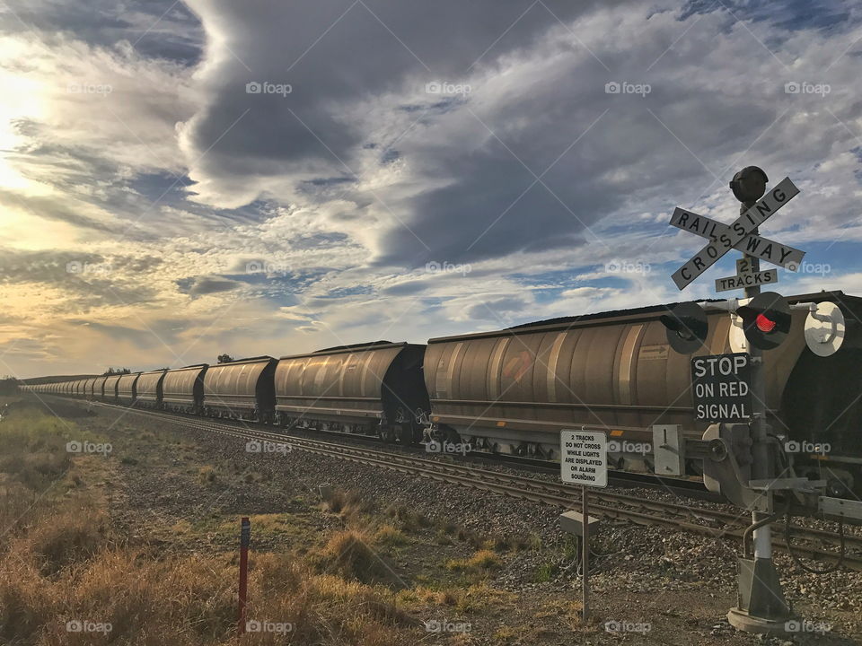 Coal train passing through railway crossing 
