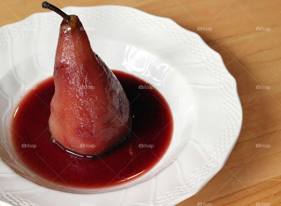 Poached stuffed pear poached in red wine