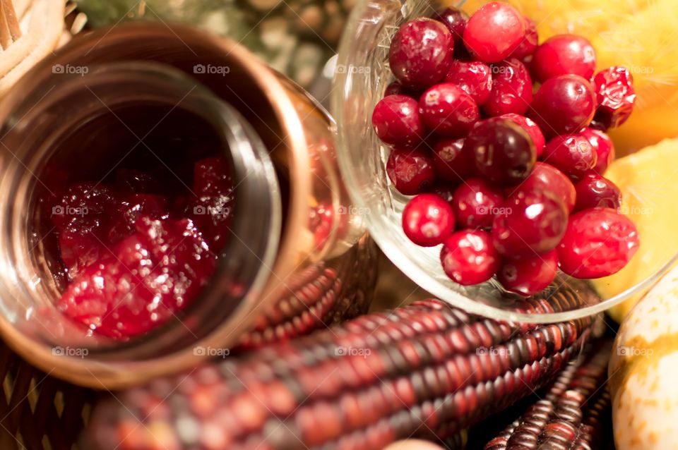 Fresh cranberries in Thanksgiving basket with homemade cranberry sauce in glass jar 