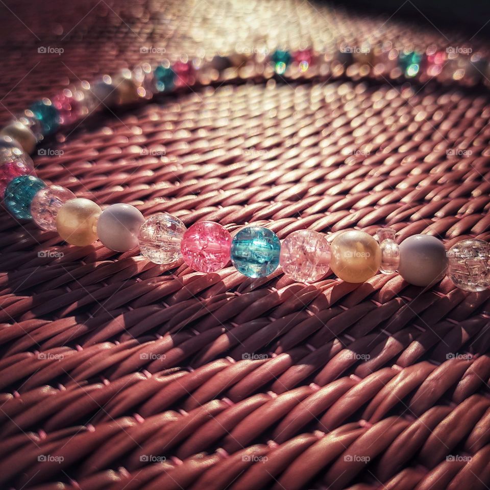 reflection of sunrays on beads and shadow