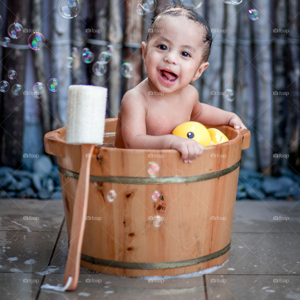 Close-up of baby bathing in bath tub