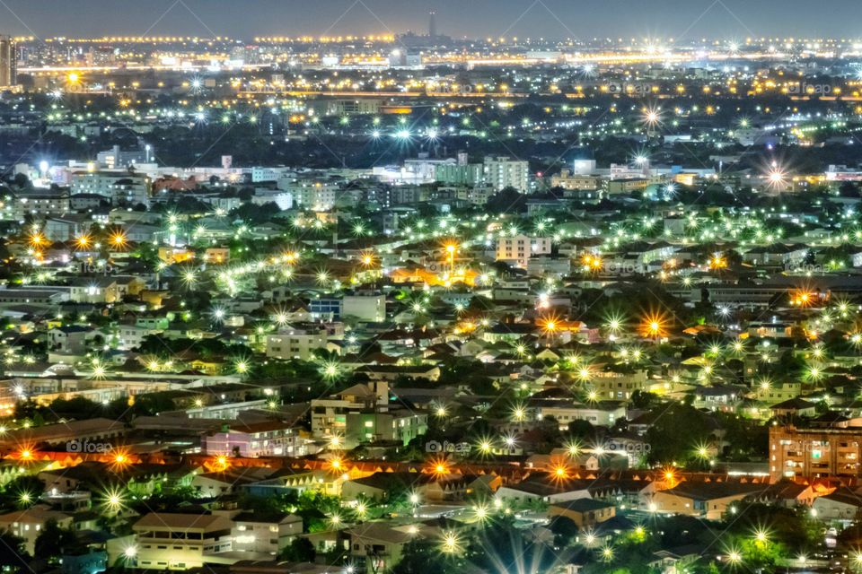 Background images of fog and dust covering the lights of buildings in Bangkok at night.