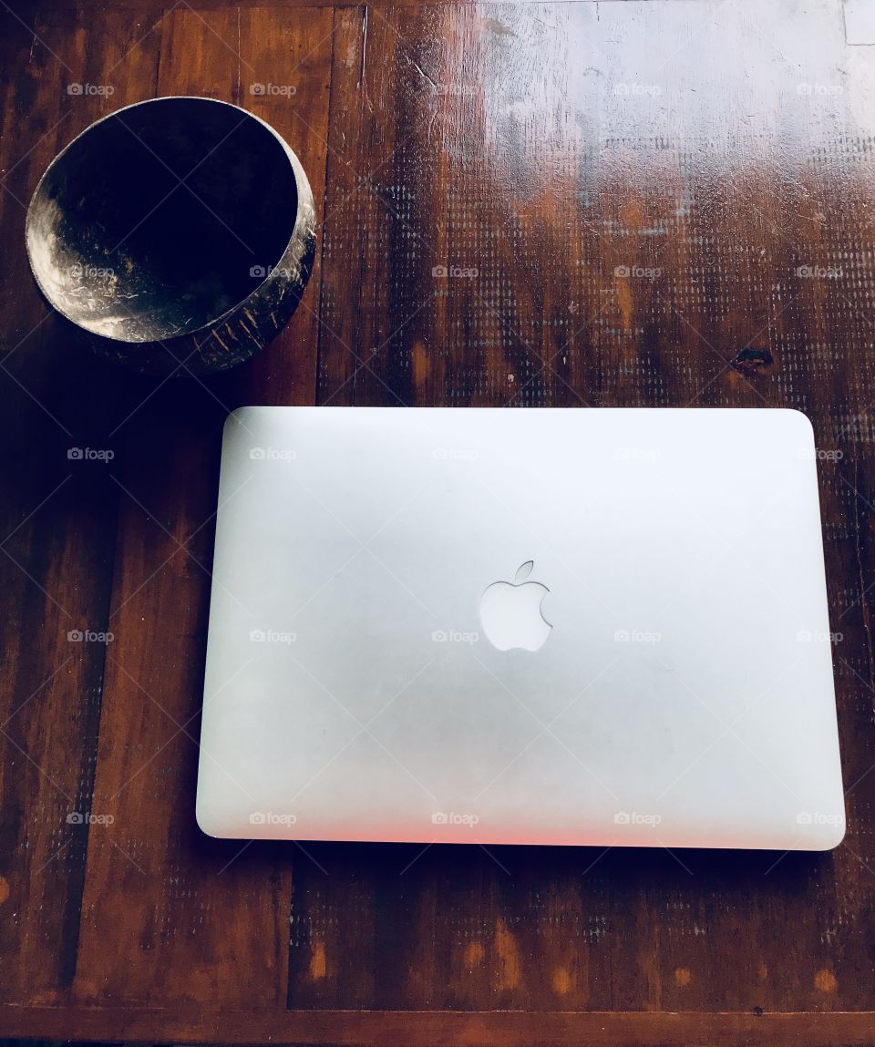 Mac book and a balistyle cup on a wooden table