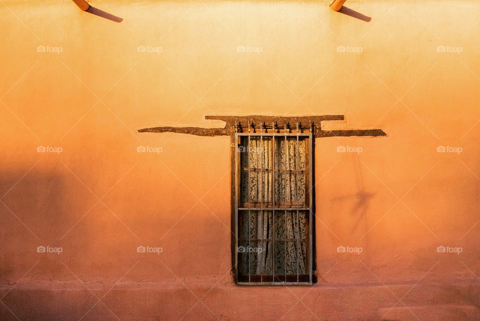 An adobe house with evening sun