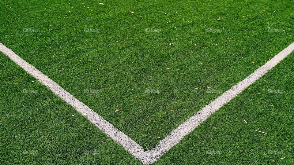 white markings on the green grass of a football field