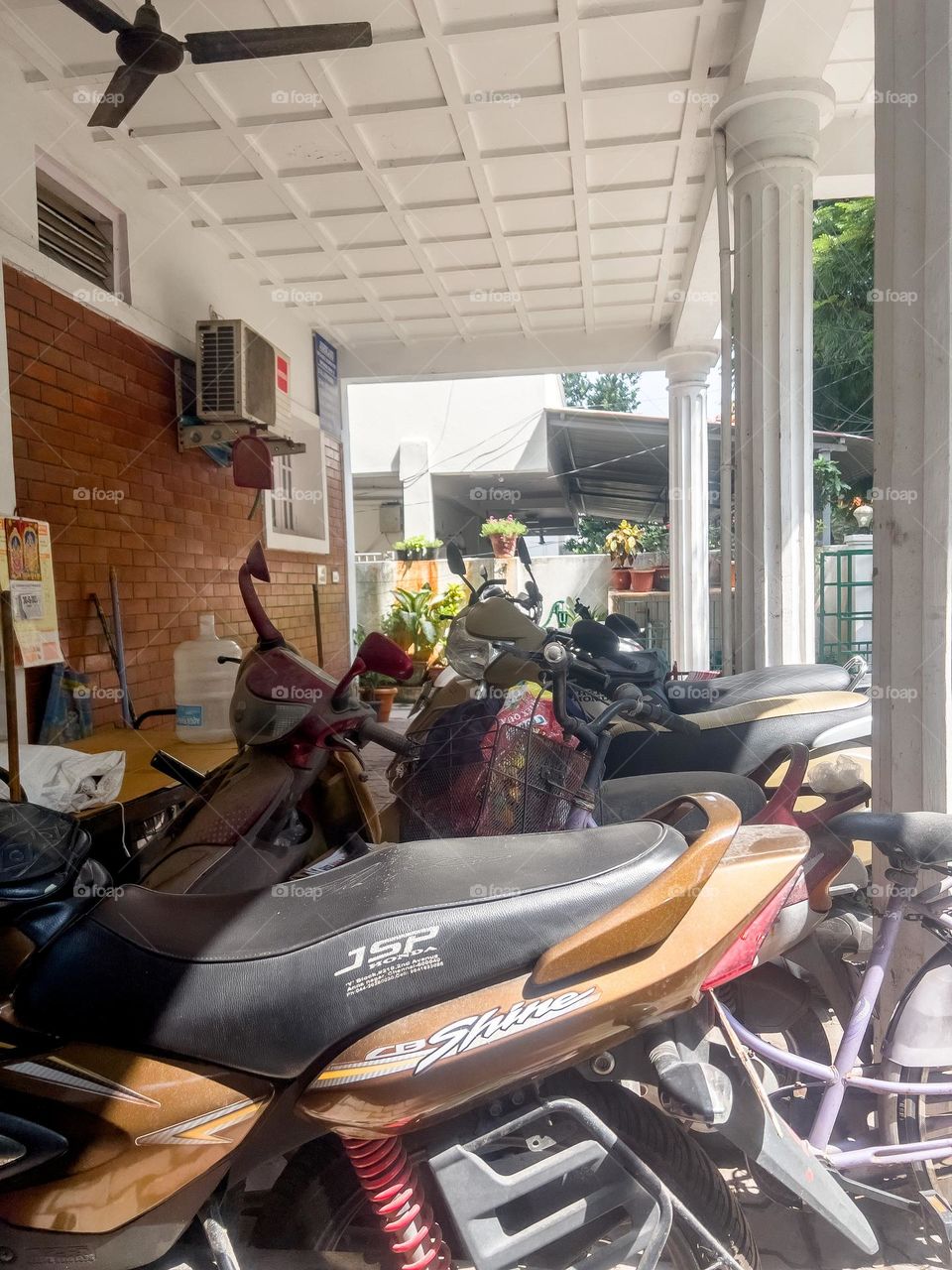 Motorbikes at a home. These are the most common form of affordable transport. It is not just more cost effective but it requires less space for parking in high density residential zones. 