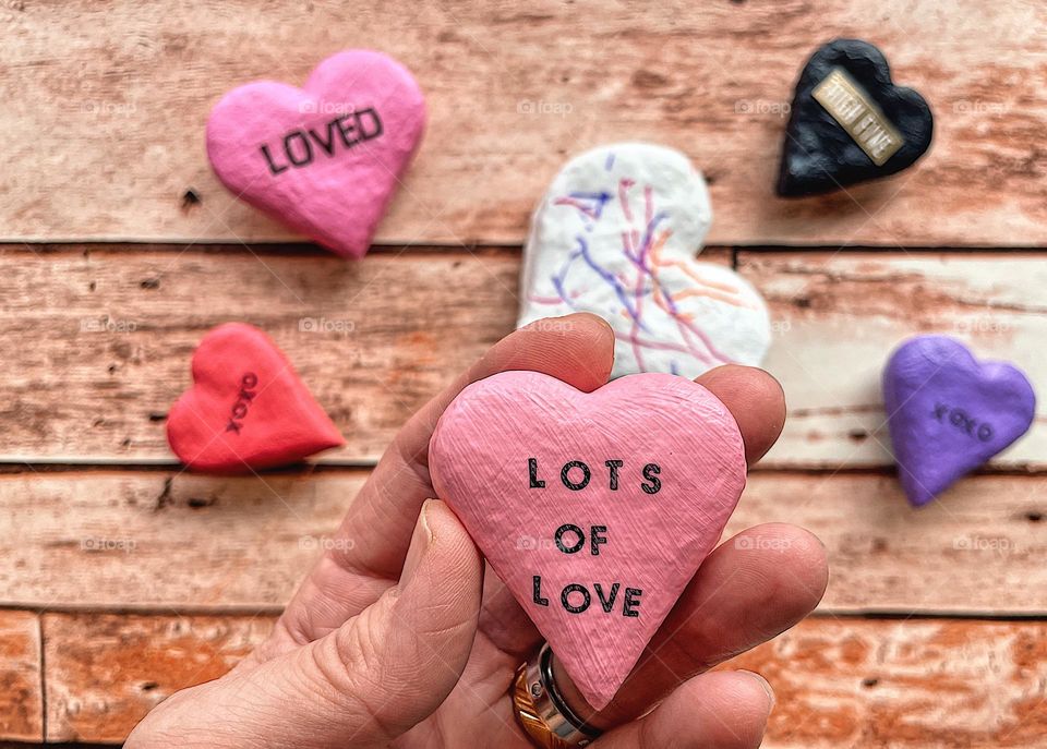 Woman’s hand holding salt dough heart magnets, making homemade Valentines, making homemade salt dough ornaments, crafting with toddlers, Valentines Day gifts at home, creating gifts at home, being creative with children 