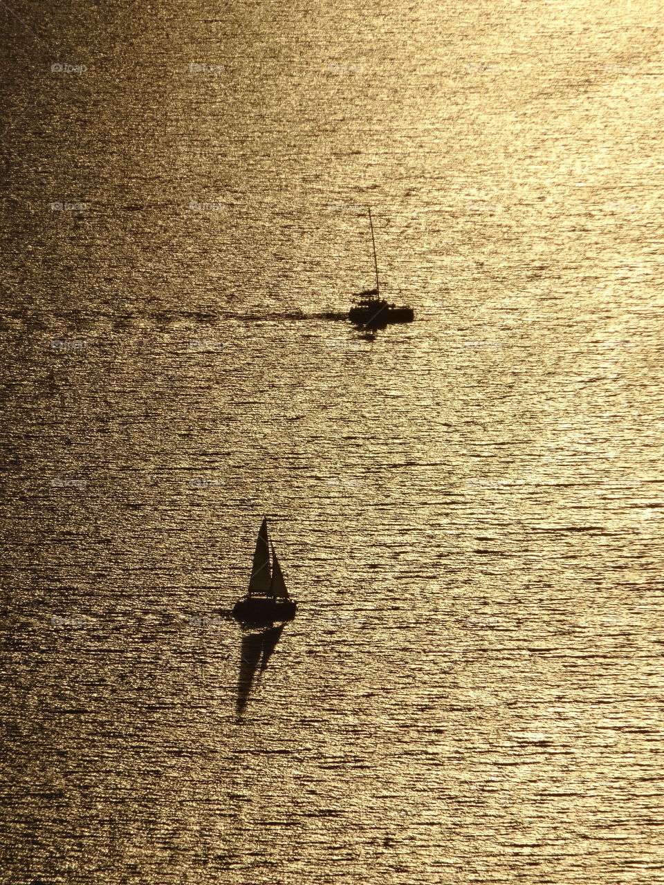 Sailboats at sunset in Santorini