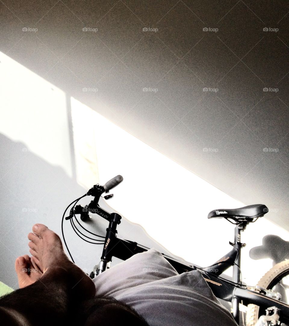 Low section of a man resting on sofa