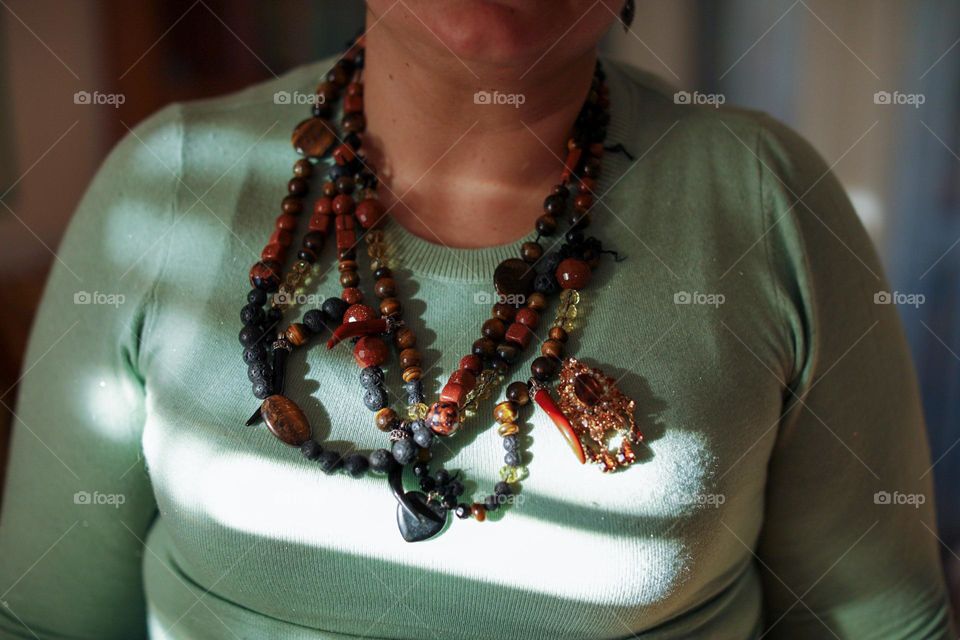 Tiger's eye, volcanic stone necklace and opal brooch