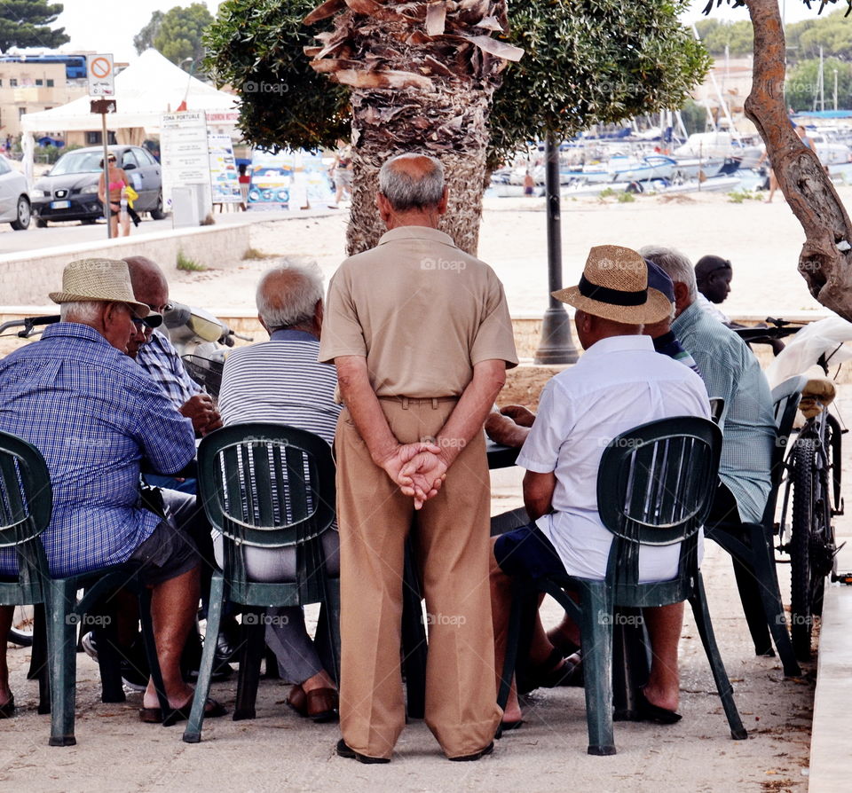 a group of old men playing a game of cards