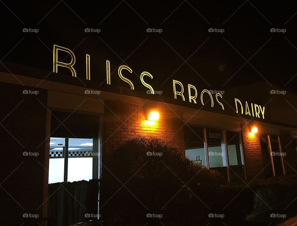 Iconic local dairy - Bliss Brothers Dairy in Attleboro Massachusetts.  Original neon lettering lights up the night sky. 