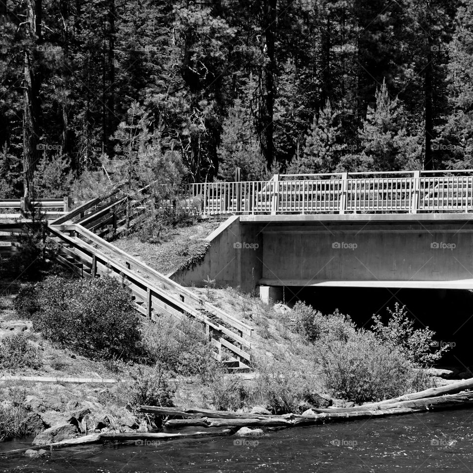 A stairway leads from a bridge down to the banks of the Deschutes River in Central Oregon. 