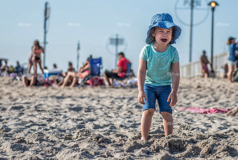 Little girl crying at beach