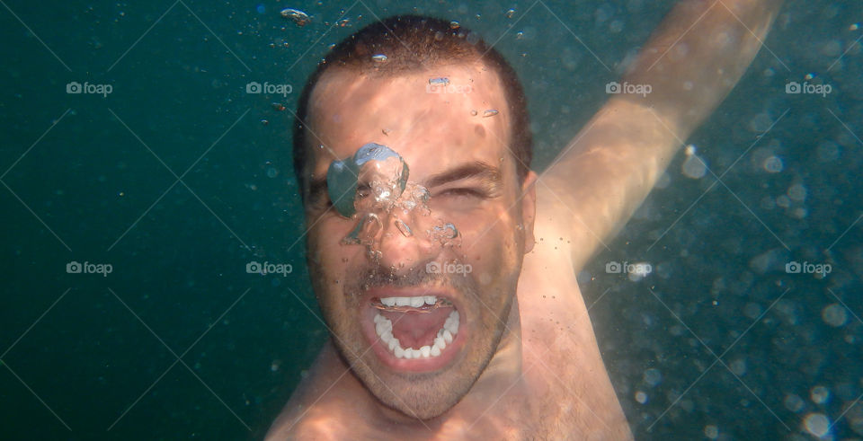 man screaming underwater