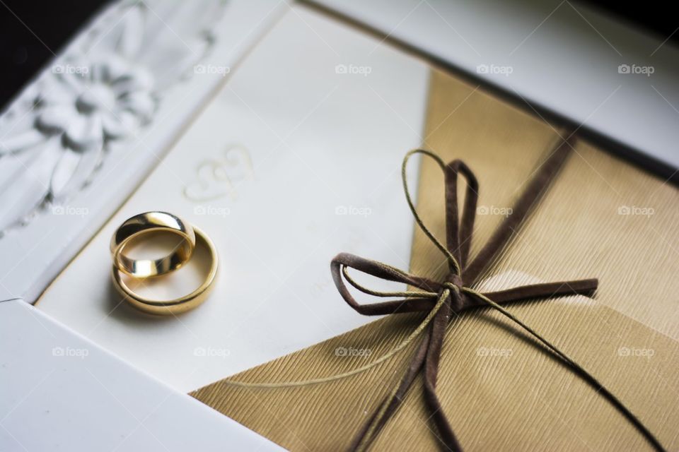 wedding rings with blank white invitation