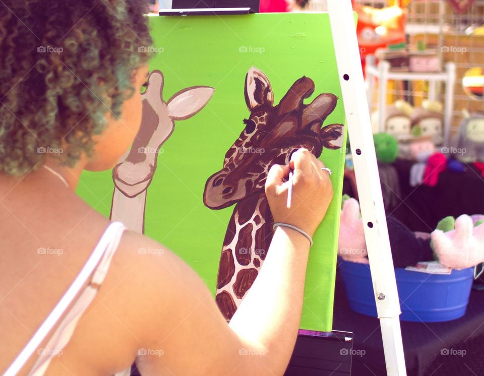 Local Artist paints a giraffe. 