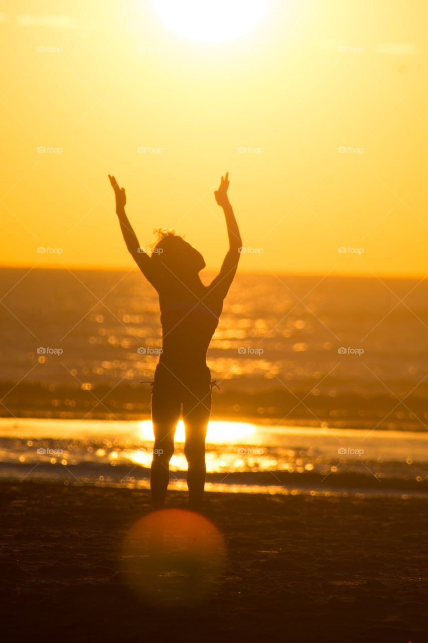 My girl trying to capture the sun during a magnificent sunset 