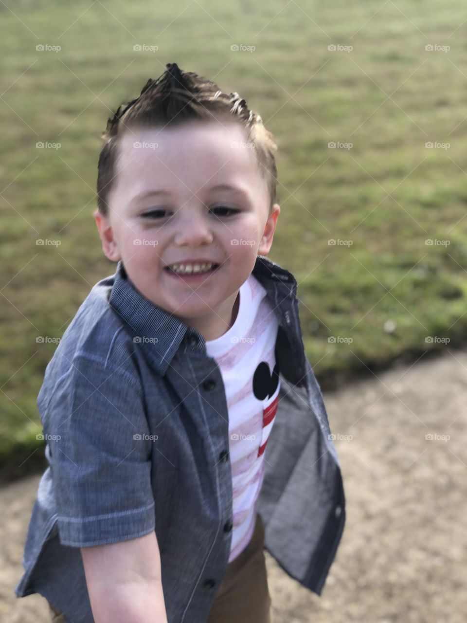 Happy boy playing outside in the sunshine 
