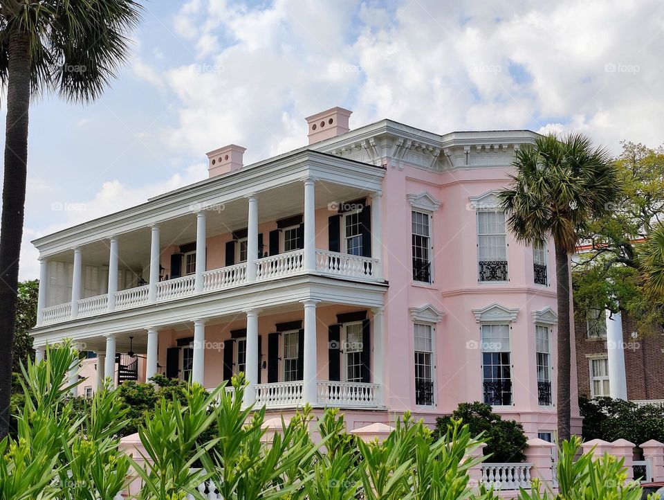 Colorful pink and white grand Barbie mansion on a sunny day